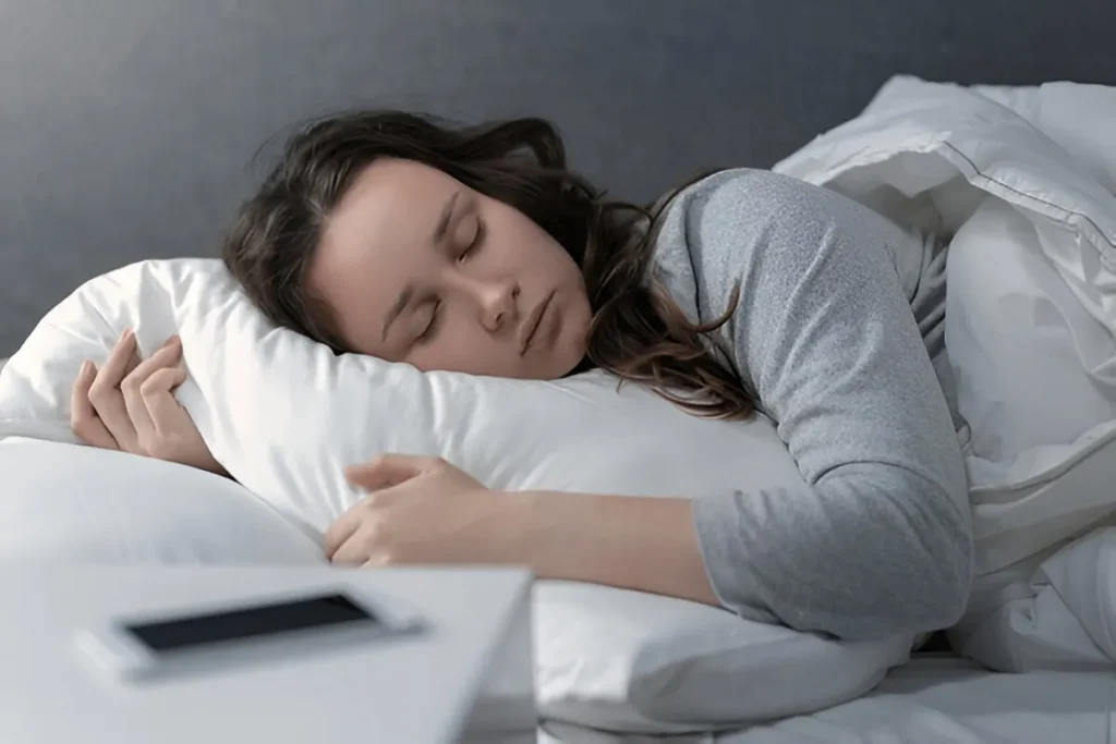 Person sleeping peacefully on a comfortable bed at night. - Stress Relief Therapies